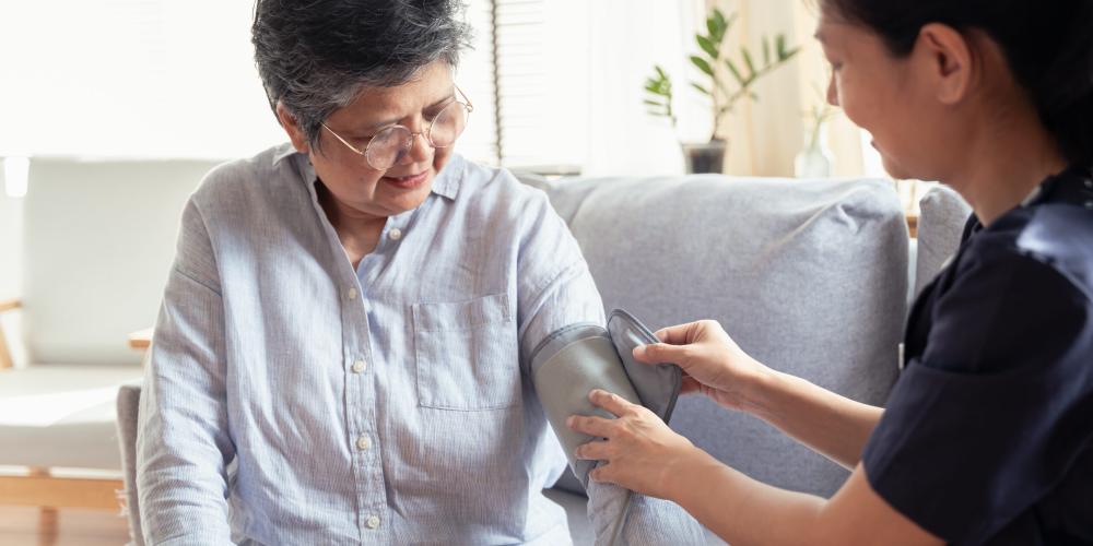 Nurse taking a patients blood pressure